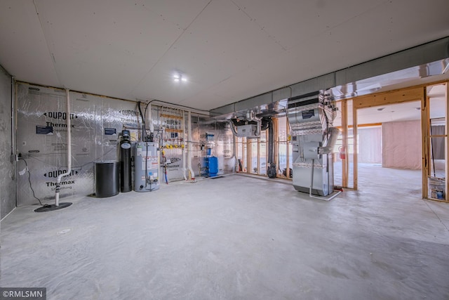 basement featuring water heater and heating unit