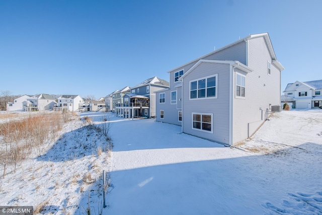 view of snow covered back of property