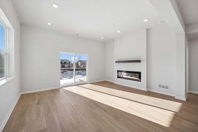 unfurnished living room featuring light wood-type flooring