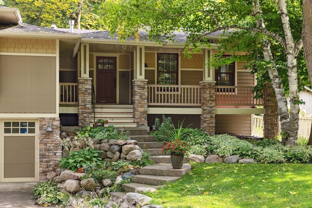 view of front of home with a garage, stone siding, a porch, and a shingled roof