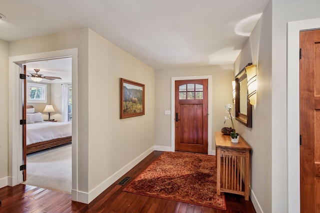 entryway featuring visible vents, baseboards, and dark wood-type flooring