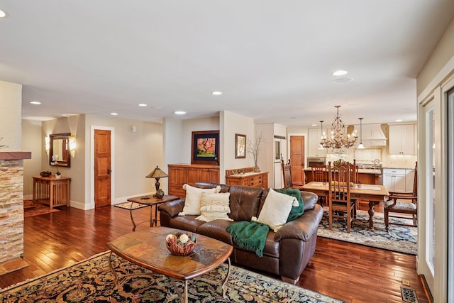 living room featuring visible vents, baseboards, dark wood finished floors, recessed lighting, and a chandelier