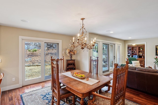 dining room featuring built in shelves, recessed lighting, baseboards, and wood-type flooring