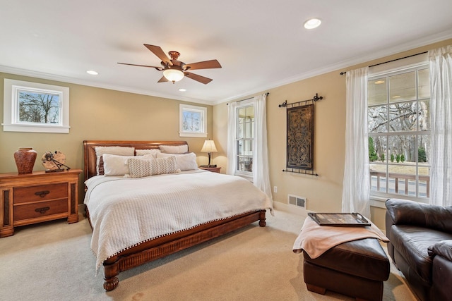 bedroom with multiple windows, visible vents, and light carpet