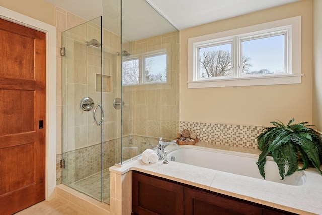 bathroom with a shower stall and a garden tub