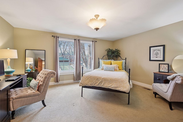 bedroom with light carpet, visible vents, and baseboards