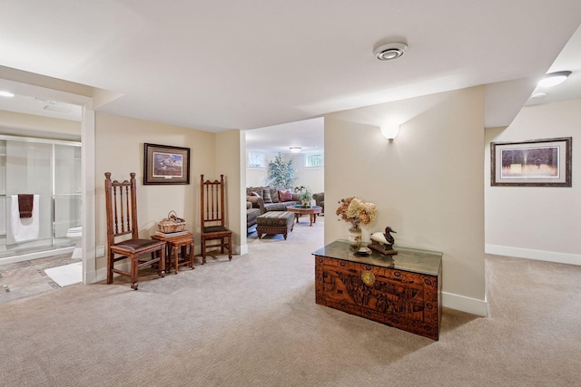 corridor featuring baseboards and carpet flooring