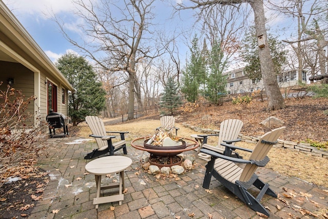 view of patio / terrace with an outdoor fire pit, fence, and a grill