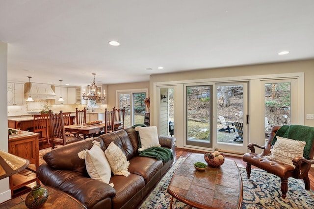 living room with healthy amount of natural light, recessed lighting, a chandelier, and wood finished floors