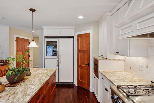 kitchen with light stone counters, tasteful backsplash, white cabinets, dark wood finished floors, and recessed lighting