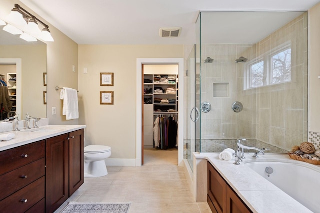 full bathroom with a stall shower, toilet, vanity, a bath, and tile patterned flooring