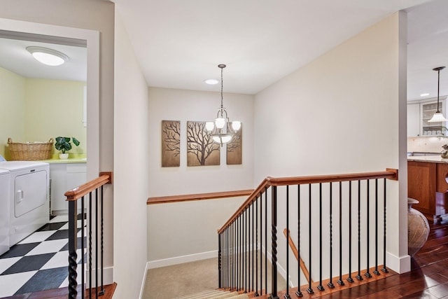stairway with washing machine and clothes dryer, recessed lighting, a chandelier, and baseboards