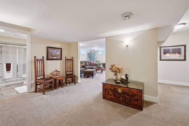 hallway with carpet floors and baseboards
