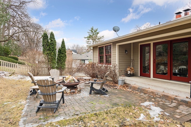 view of patio with an outdoor fire pit and fence