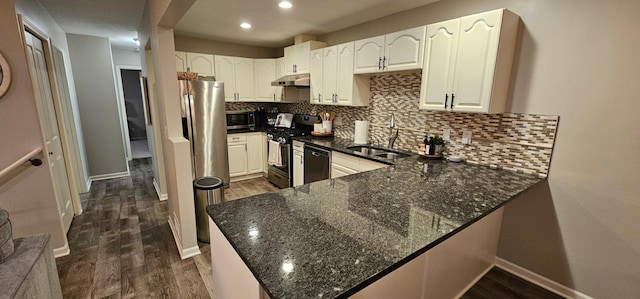 kitchen with white cabinetry, sink, stainless steel gas range, and kitchen peninsula