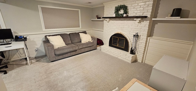 carpeted living room featuring crown molding and a brick fireplace