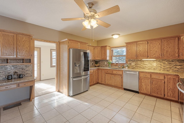 kitchen featuring tasteful backsplash, ceiling fan, appliances with stainless steel finishes, and light tile patterned floors