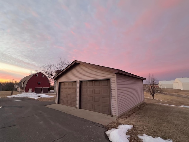 view of garage at dusk