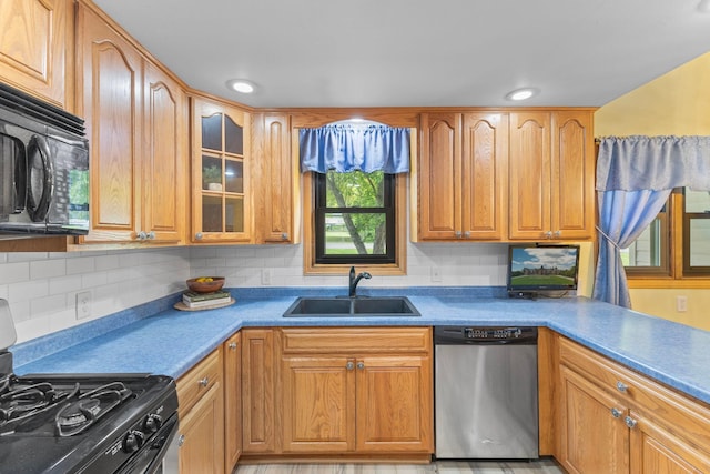 1697 Shore Dr, Arthur Twp, MN 55051 - kitchen featuring dishwasher, a sink, gas stove, black microwave, and glass insert cabinets