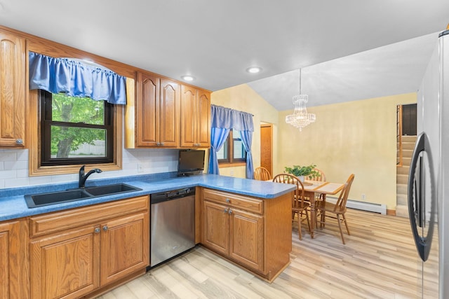 1697 Shore Dr, Arthur Twp, MN 55051 - kitchen with stainless steel appliances, a sink, a peninsula, a chandelier, and light wood finished floors