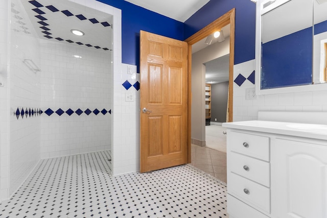 1697 Shore Dr, Arthur Twp, MN 55051 - bathroom with tile walls, vanity, tiled shower, and tile patterned flooring
