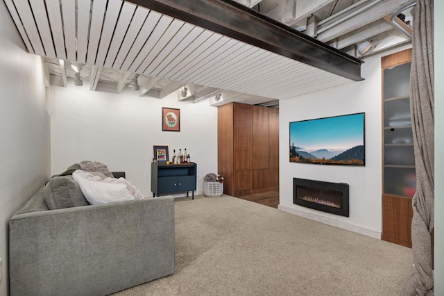 living room with beamed ceiling and carpet flooring