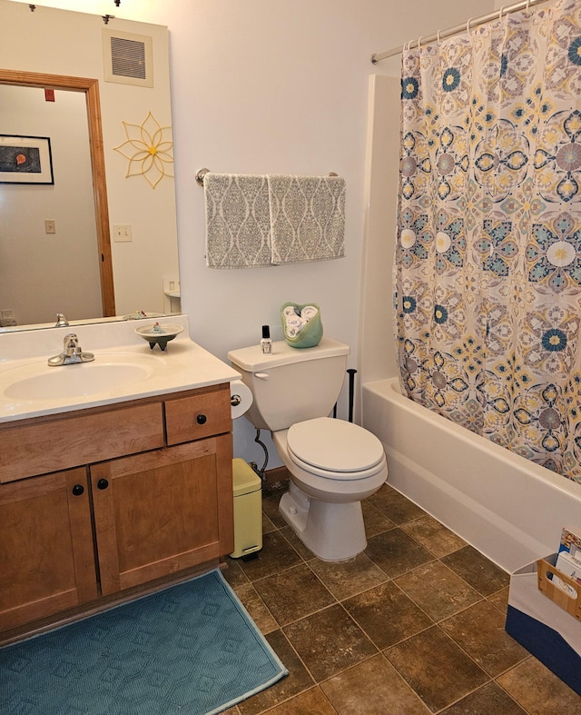 full bathroom featuring shower / bath combo, vanity, and toilet