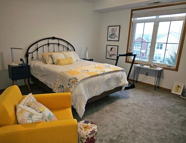 carpeted bedroom featuring visible vents and baseboards