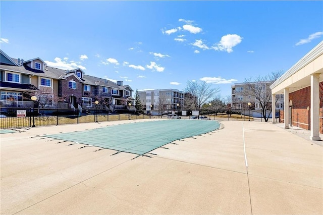 pool featuring fence and a patio