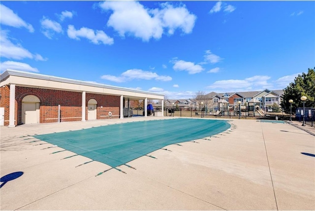 pool featuring a residential view, fence, and a patio