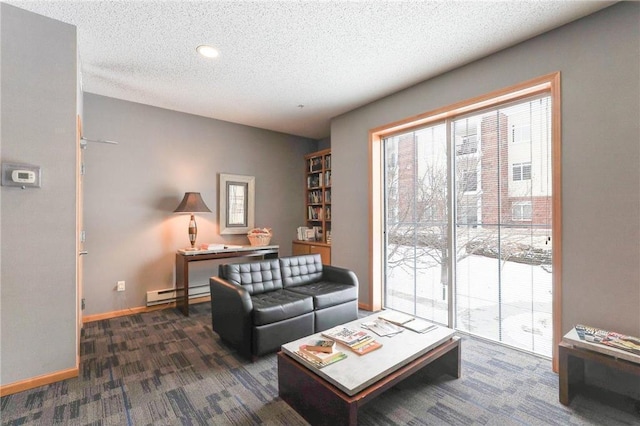 living area with a textured ceiling, baseboard heating, dark carpet, and baseboards