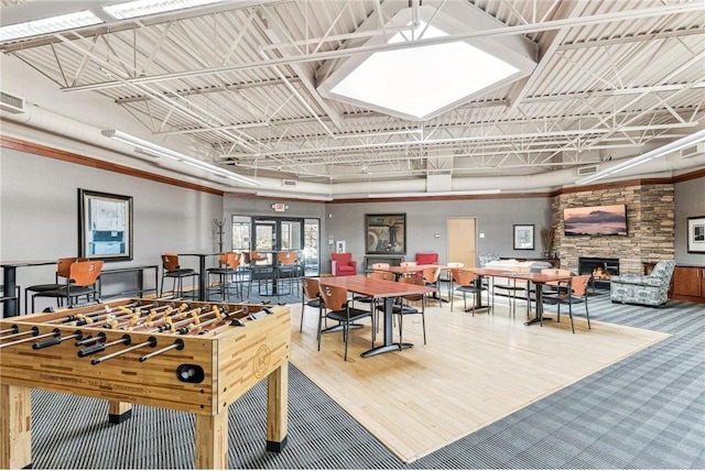 recreation room with a skylight, a fireplace, and visible vents