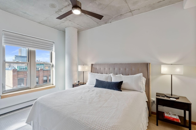 bedroom featuring a baseboard heating unit and ceiling fan