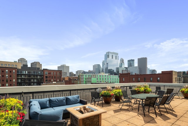 view of patio with an outdoor living space with a fire pit