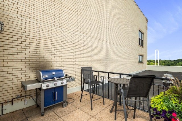 view of patio / terrace with grilling area and a balcony