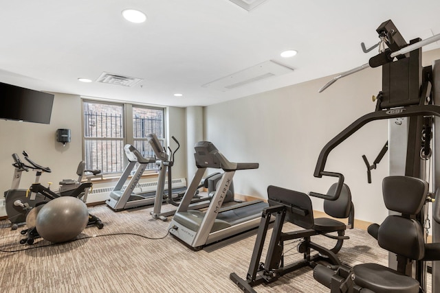 workout room with floor to ceiling windows and light carpet