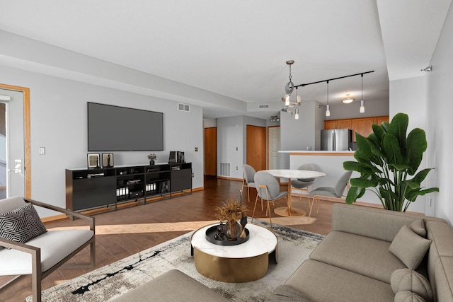 living room with hardwood / wood-style floors and track lighting