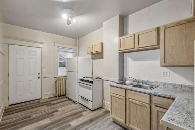 kitchen with light brown cabinetry, sink, white appliances, and light hardwood / wood-style flooring