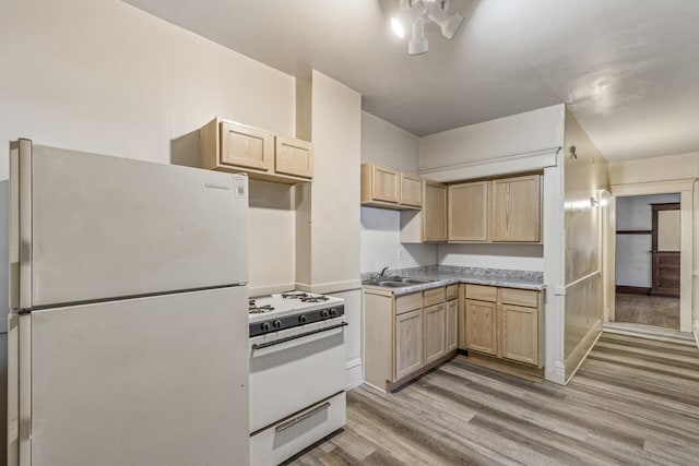 kitchen with white appliances, sink, light wood-type flooring, and light brown cabinets