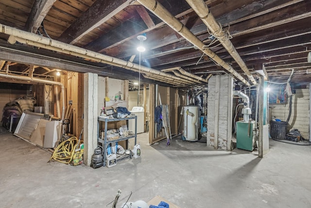 basement featuring washer / clothes dryer and water heater