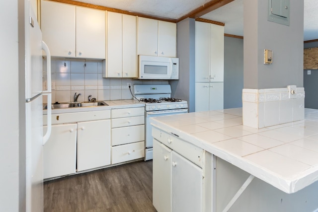 kitchen with sink, tile countertops, white cabinets, and white appliances