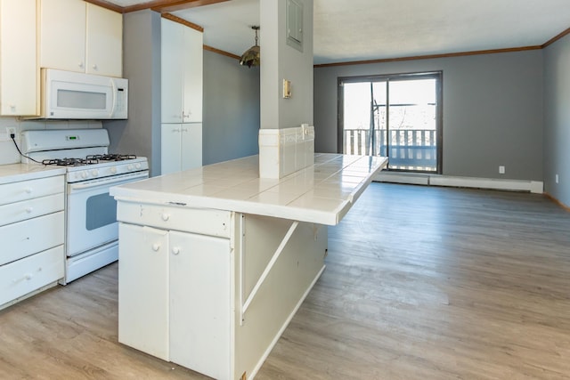 kitchen with crown molding, white appliances, tile countertops, and white cabinets