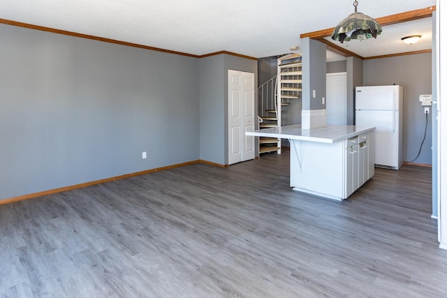 kitchen featuring decorative light fixtures, white cabinets, white fridge, tile counters, and dark wood-type flooring