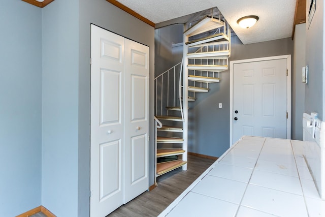 foyer with hardwood / wood-style floors and a textured ceiling