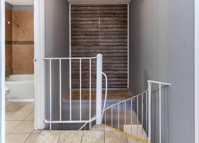 stairway featuring tile patterned floors