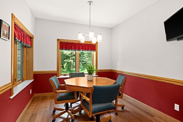 dining room with an inviting chandelier and hardwood / wood-style flooring