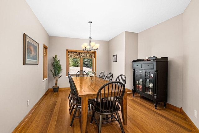 dining space with a chandelier and hardwood / wood-style floors