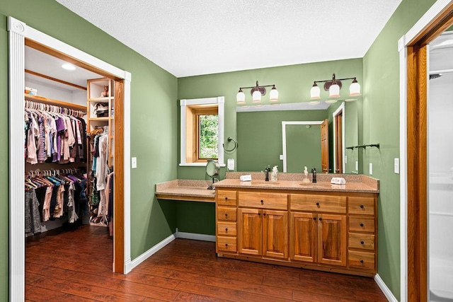 bathroom with vanity, hardwood / wood-style floors, and a textured ceiling