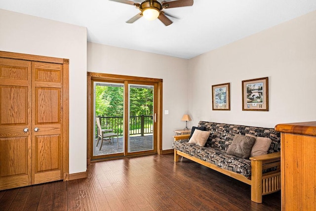 sitting room featuring dark wood-type flooring and ceiling fan