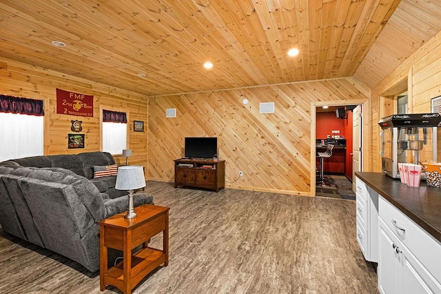 living room with wooden walls, dark hardwood / wood-style flooring, vaulted ceiling, and wooden ceiling